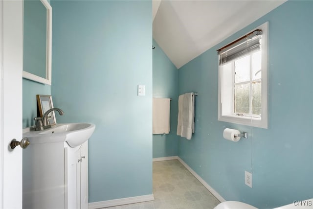 bathroom featuring vanity and vaulted ceiling