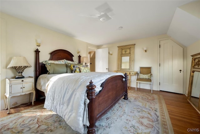 bedroom featuring light hardwood / wood-style floors and vaulted ceiling