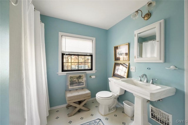 bathroom with tile patterned flooring and toilet