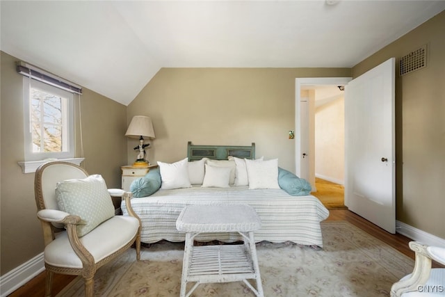 bedroom featuring light hardwood / wood-style flooring and vaulted ceiling