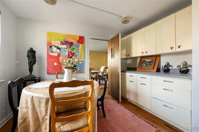 dining area with dark wood-type flooring