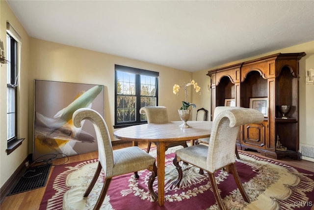 dining space with dark hardwood / wood-style flooring