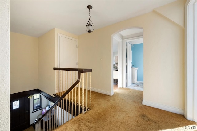 hallway with light colored carpet