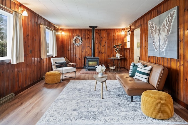 sitting room with hardwood / wood-style floors and a wood stove