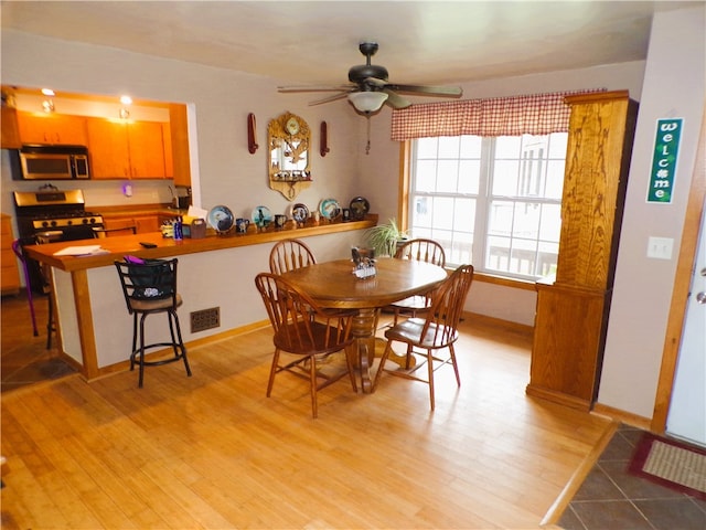 dining area featuring ceiling fan and light hardwood / wood-style floors