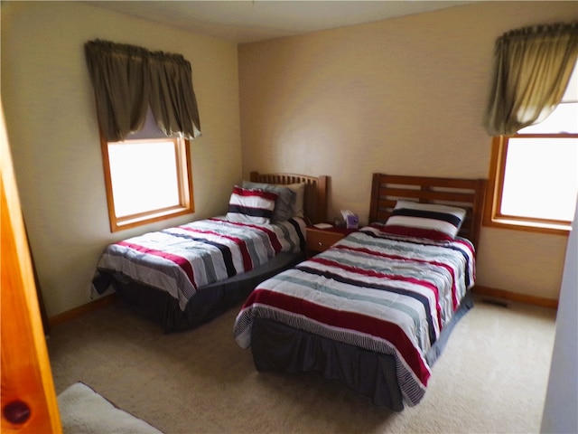 carpeted bedroom featuring multiple windows