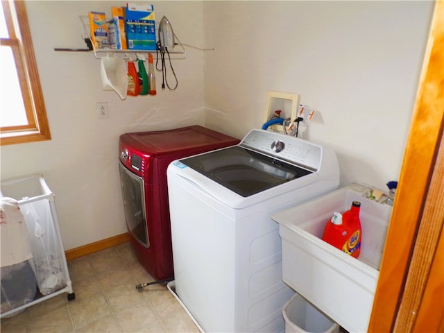 washroom with washer and clothes dryer and sink