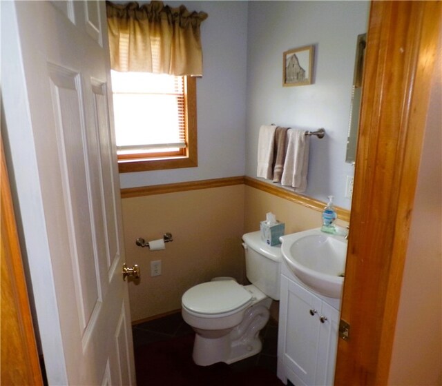 bathroom featuring tile patterned flooring, vanity, and toilet