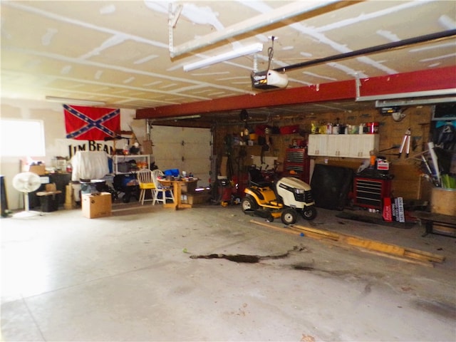 garage with a workshop area and a garage door opener