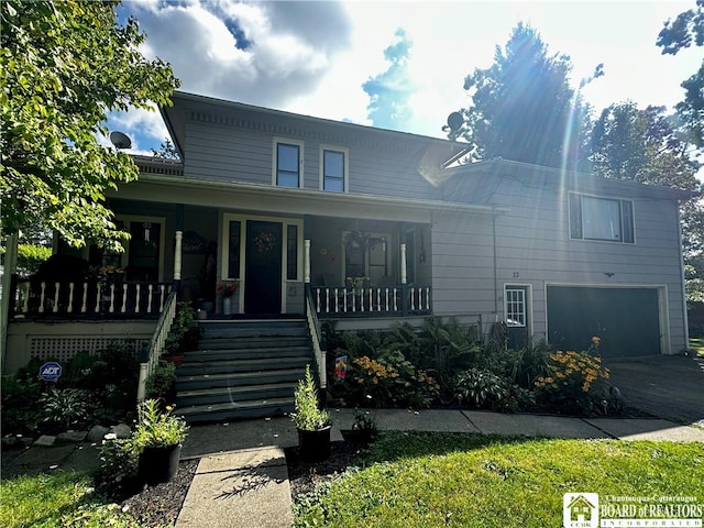 view of front of home featuring covered porch and a garage