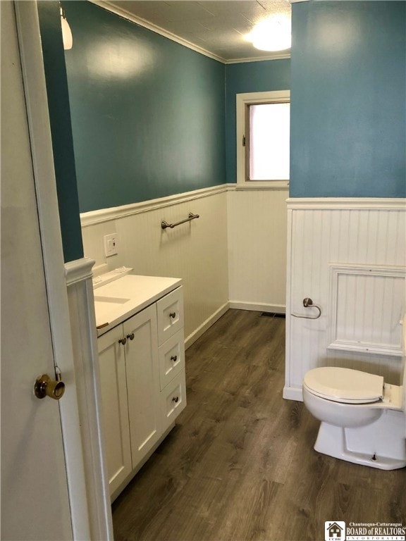 bathroom featuring crown molding, toilet, vanity, and hardwood / wood-style flooring