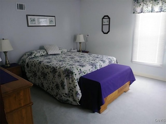 carpeted bedroom featuring multiple windows