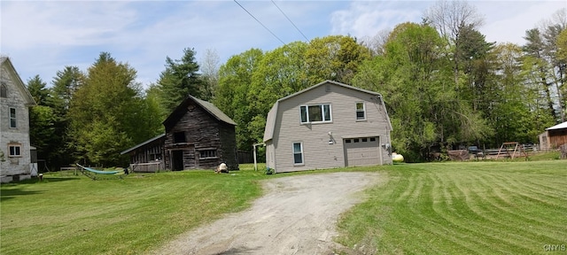 1389 Carver Falls Ln, Hampton, NY 12887 - view of side of property with driveway, a barn, a yard, and view of scattered trees