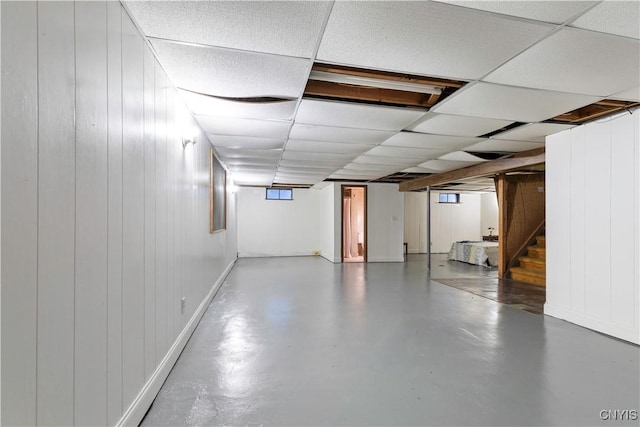 basement with a paneled ceiling