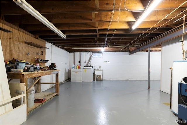 basement featuring a workshop area, sink, and washer and dryer