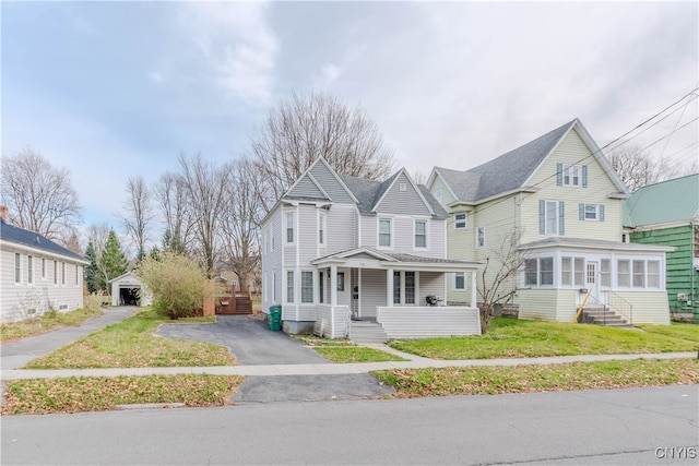 view of front of home with a front yard and a porch