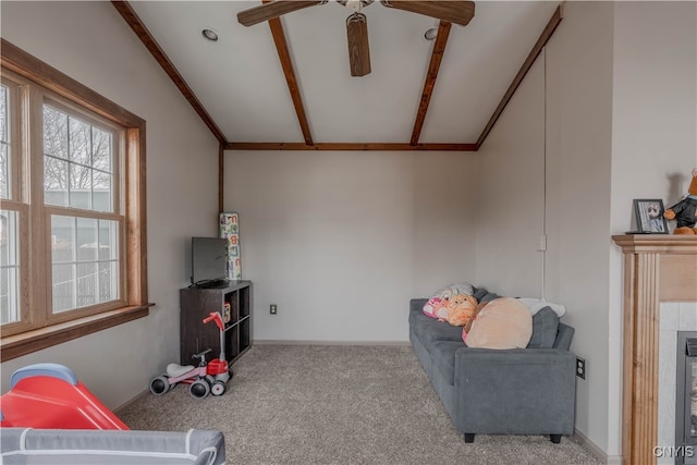 sitting room featuring lofted ceiling with beams, light colored carpet, and ceiling fan