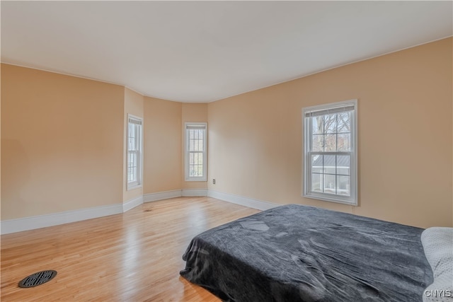 bedroom with wood-type flooring