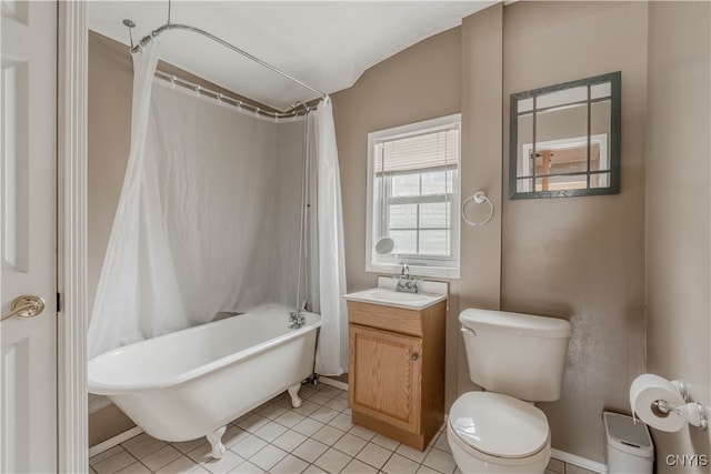 full bathroom featuring tile patterned floors, shower / bath combo with shower curtain, vanity, and toilet