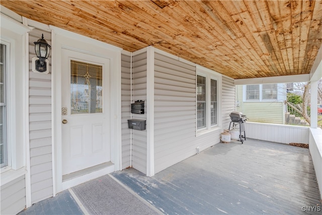 view of exterior entry featuring covered porch