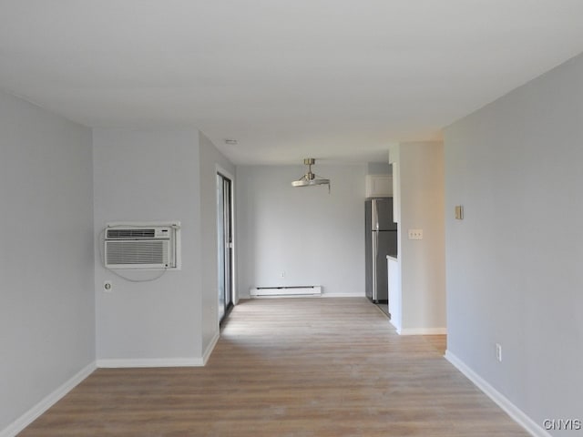 corridor featuring a wall mounted air conditioner, light hardwood / wood-style floors, and a baseboard radiator