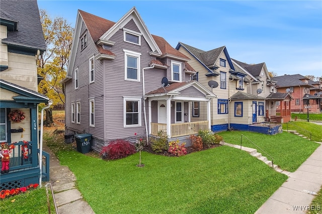 view of front of home with a front yard and covered porch