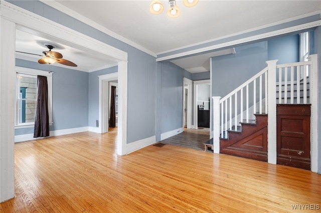 interior space with ceiling fan, ornamental molding, and light hardwood / wood-style flooring