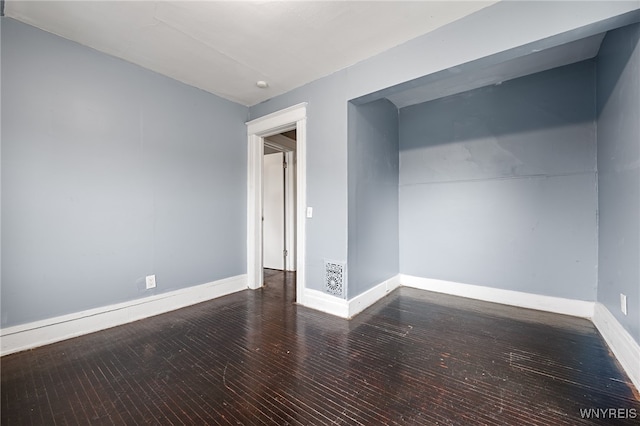 spare room featuring dark hardwood / wood-style floors