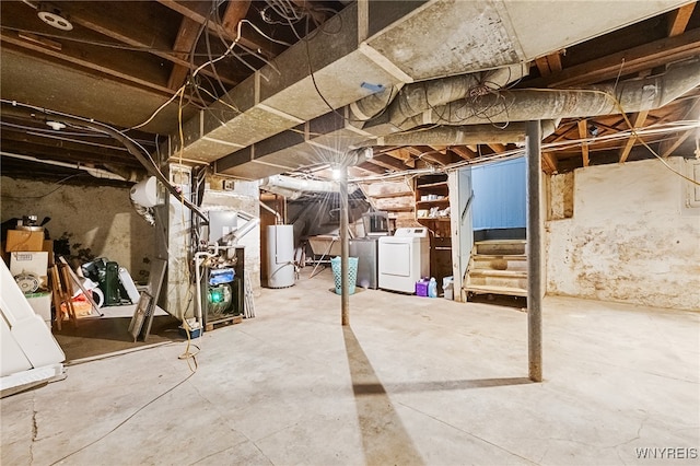 basement featuring separate washer and dryer, gas water heater, and heating unit