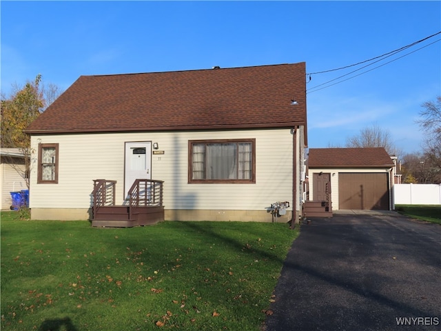 view of front of home with a front yard and a garage