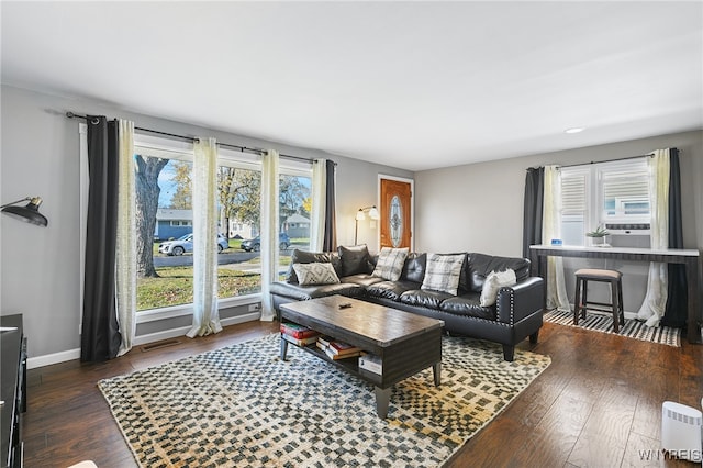 living room with a healthy amount of sunlight and dark hardwood / wood-style floors