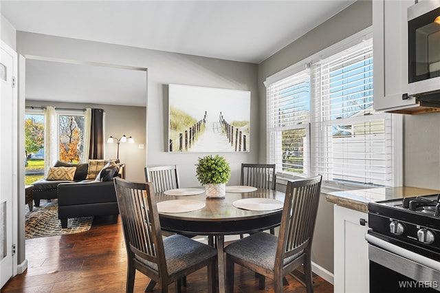 dining space with dark hardwood / wood-style floors