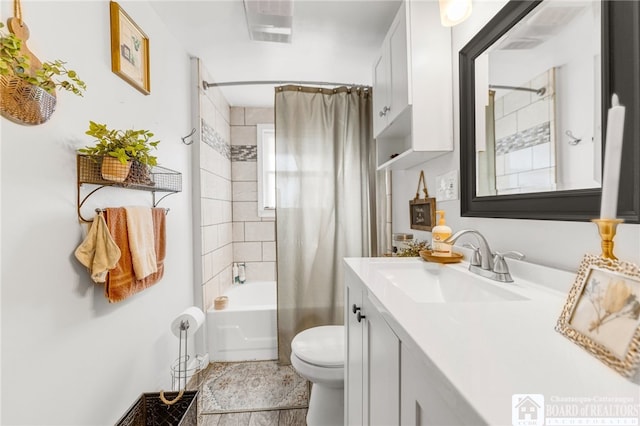 full bath featuring shower / bath combo with shower curtain, toilet, and vanity