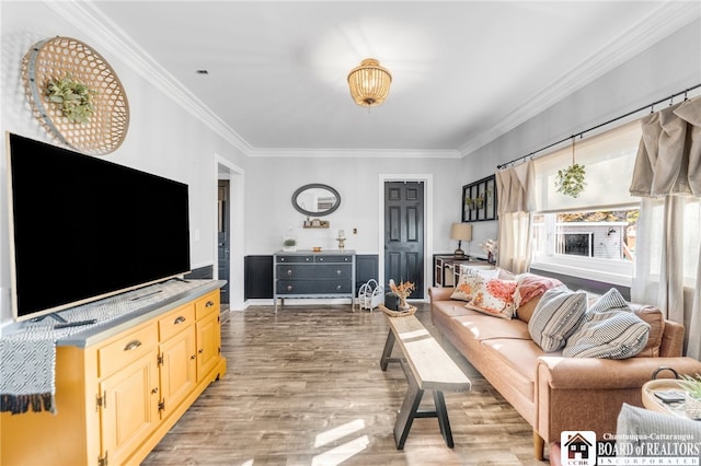 living area with crown molding and light wood finished floors