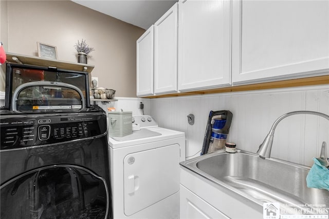 laundry room with a sink, cabinet space, and washer and dryer