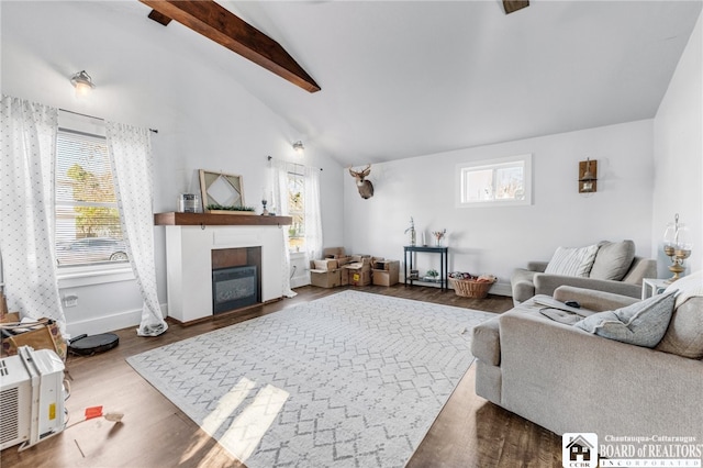 living room with wood finished floors, baseboards, high vaulted ceiling, a glass covered fireplace, and beamed ceiling