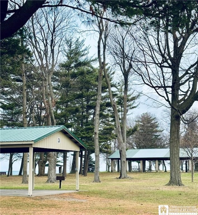 surrounding community featuring a gazebo, a yard, and a carport