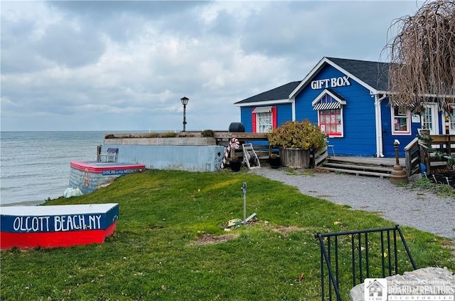 exterior space with a yard and a water view