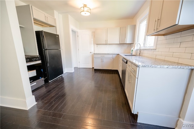 kitchen featuring appliances with stainless steel finishes, backsplash, sink, dark hardwood / wood-style floors, and white cabinetry