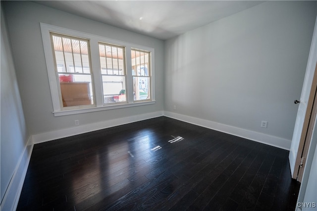 spare room featuring dark hardwood / wood-style floors