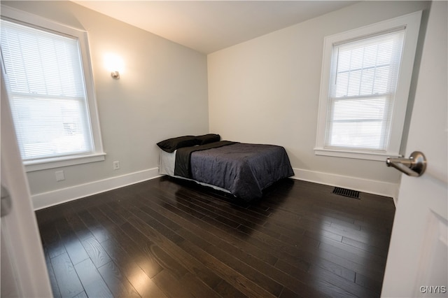 bedroom featuring dark hardwood / wood-style flooring