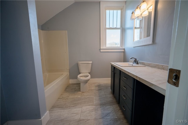 bathroom with vanity, vaulted ceiling, and toilet