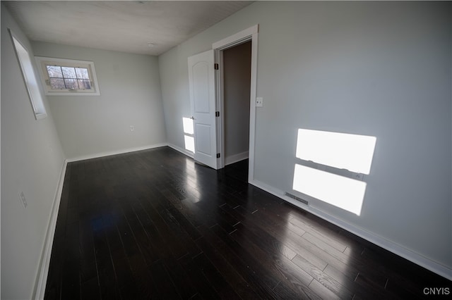 spare room featuring dark hardwood / wood-style floors