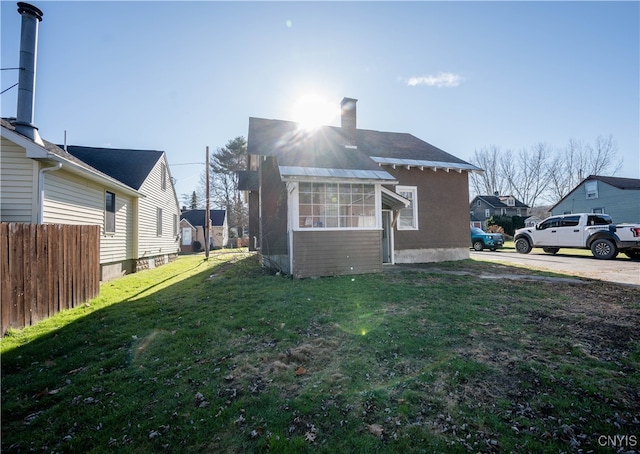 view of side of home featuring a yard