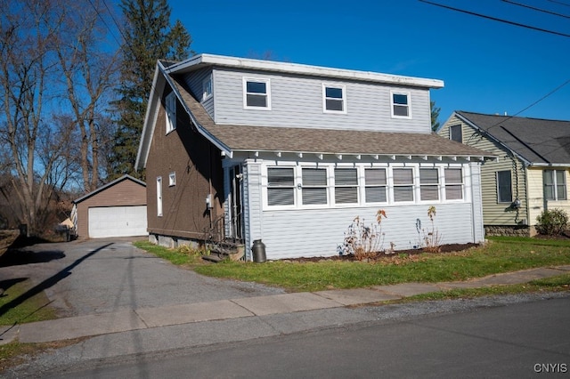 view of front of house with a garage and an outdoor structure