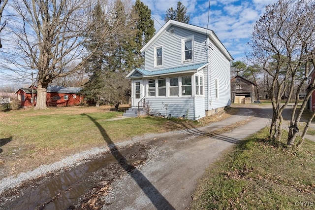 view of front of property with a front lawn and a carport