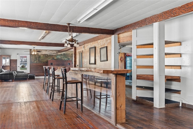 kitchen with beam ceiling, dark hardwood / wood-style flooring, and ceiling fan