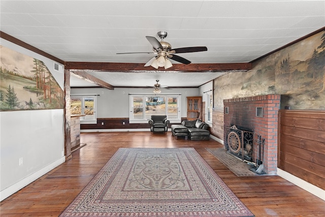 living room featuring a brick fireplace, ceiling fan, beamed ceiling, and hardwood / wood-style flooring