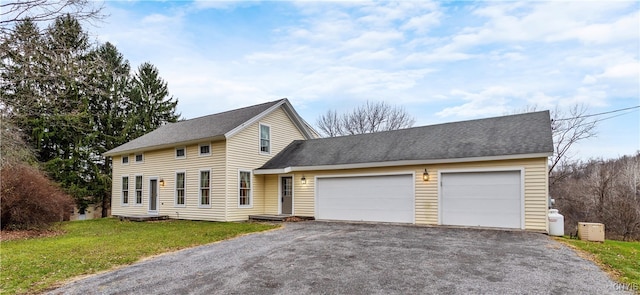 view of front of home with a front lawn and a garage