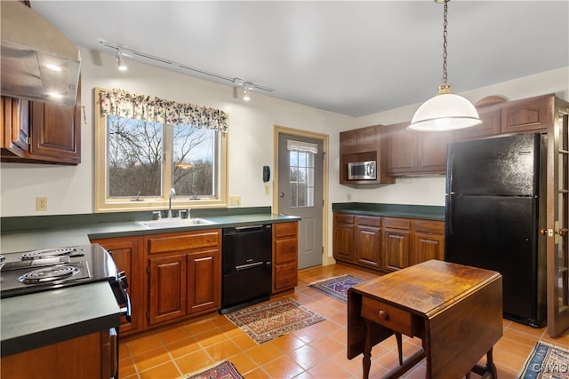 kitchen featuring sink, rail lighting, pendant lighting, light tile patterned flooring, and black appliances